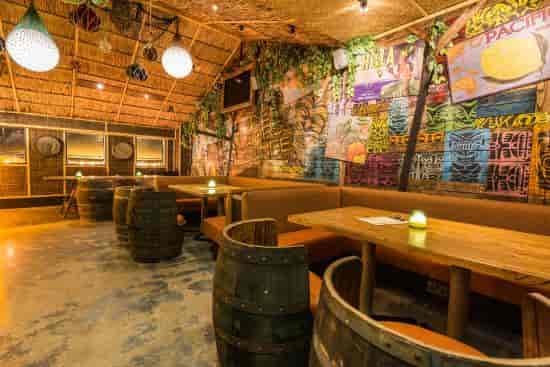 Tropical-themed Liars Lounge with rustic decor for casual meetings and social events.