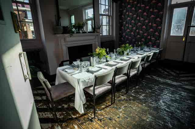 Elegant long dining table in The Sanctuary, perfect for private dinners and gatherings.