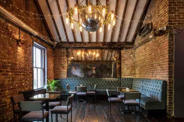 Stylish event space with exposed brick, ideal for networking and gatherings.