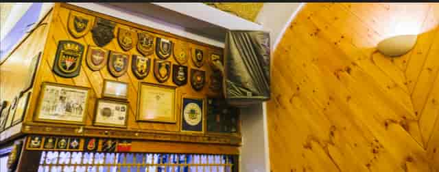Main Hall in Moth Club with award plaques, perfect for events and presentations.