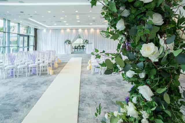 Modern wedding ceremony setup in Garden Suite with floral arch, perfect for intimate celebrations.