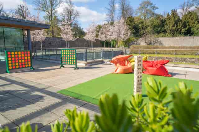 Garden Suite outdoor breakout area with beanbags for corporate events and networking.