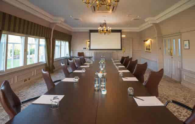 Verandah boardroom with leather chairs and projector at Norton House Hotel corporate meeting room