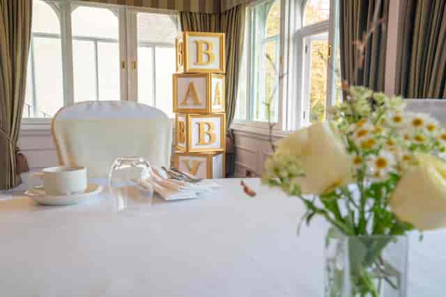 Baby shower banquet setup at Norton House Hotel with elegant floral decor and white linens.