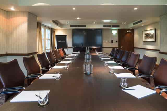 Boardroom at Norton House Hotel & Spa featuring wood table for executive meetings and workshops.