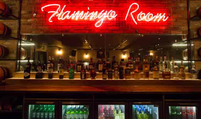 Vibrant bar at O'Neill's Wardour Street with neon sign, perfect for networking events.