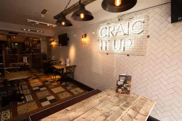 Vibrant event space at O'Neill's Wardour Street with neon sign for gatherings and networking.