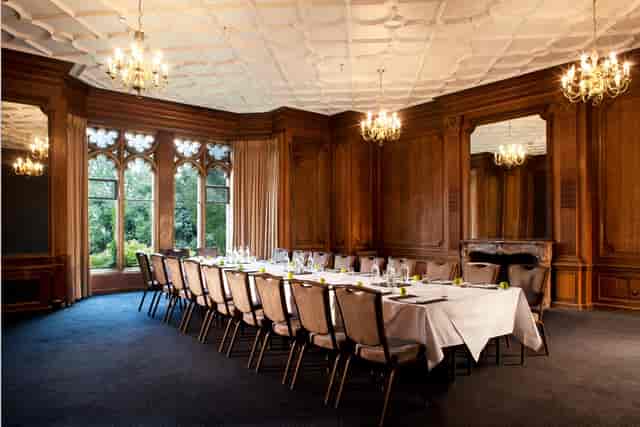 Gibson Room at Nutfield Priory: elegant meeting space with wooden paneling for exclusive events.