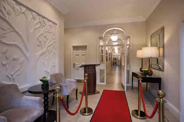 Elegant entrance at Crathorne Hall Hotel with red carpet for luxury events.