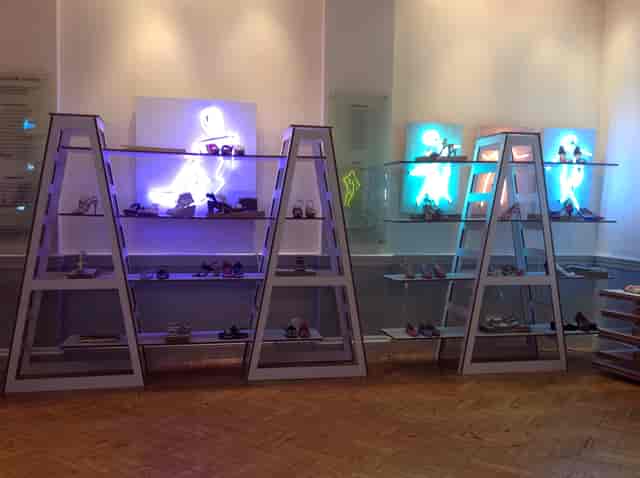 Stylish shoe display in modern shelving at The Hellenic Centre for fashion events.