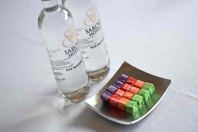 Malvern Suite at The Abbey Hotel with branded water and colorful candies for events.