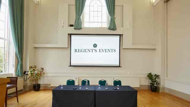 Herringham Hall event space with central screen, ideal for corporate meetings and conferences.