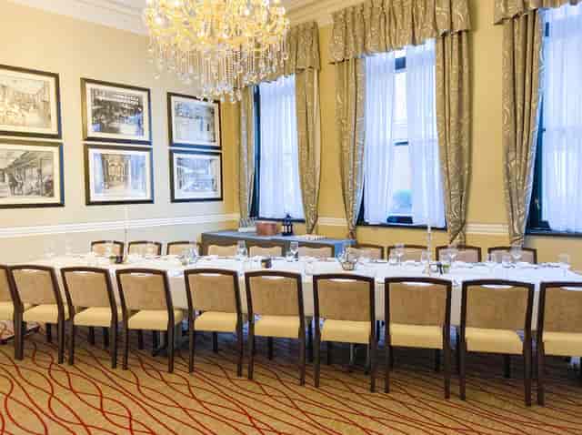 Elegant Melville Room with chandelier, perfect for corporate meetings and events.