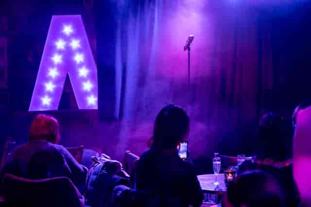 Vibrant Phoenix Arts Club venue with spotlighted microphone for live music or comedy events.