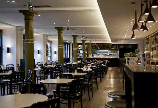 Eastway Restaurant dining area with round tables, perfect for events and meetings.