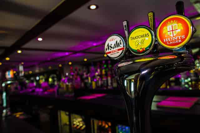 Hunt's Lounge bar with illuminated taps, perfect for networking events and social gatherings.