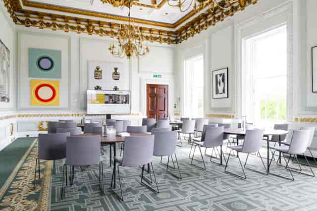 Sophisticated Radhakrishnan Room with high ceilings for workshops and meetings.