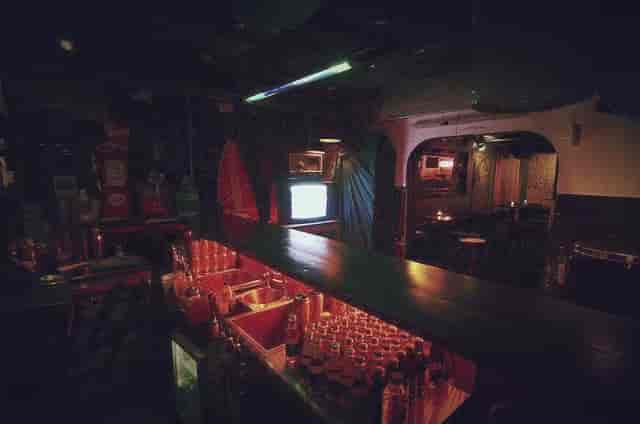 Intimate bar setting at The BSMT, warm lighting for networking events and gatherings.