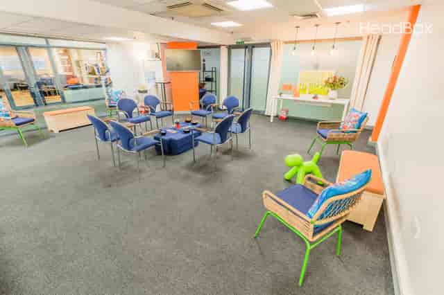 Vibrant White Room at Impact Factory for creative workshops and informal gatherings.