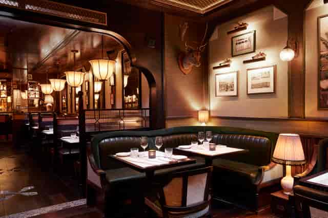 Sophisticated dining space for upscale events at Gymkhana, ideal for corporate gatherings.