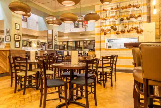 Napoli Room dining space with warm lighting, ideal for networking events and gatherings.