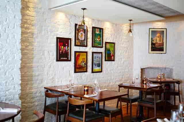 Stylish restaurant interior with white brick wall, perfect for intimate gatherings and events.