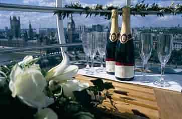 Elegant London Eye capsule setup for luxury events with champagne and city views.
