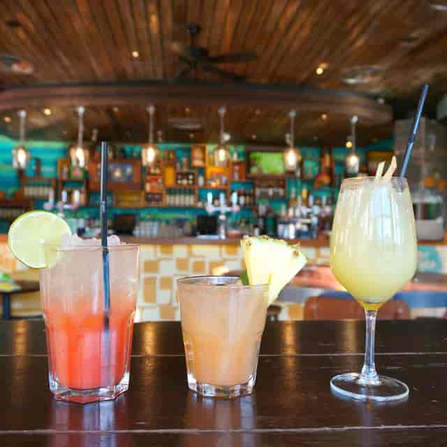 Colorful cocktails in vibrant bar setup at Las Iguanas Edinburgh for events and gatherings.