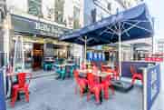 Private room outdoor dining area with vibrant furniture for casual meetings in Leicester Square.