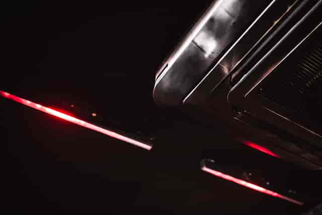 Sleek ceiling fixture with red lighting at The Blackbox, ideal for events and meetings.