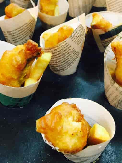 Bite-sized fried snacks in paper cups at Dragon's & Lion's Suites, perfect for networking events.