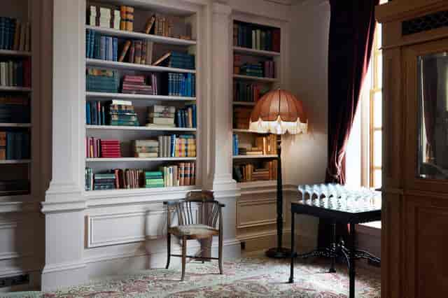 Sophisticated meeting space in The Ned with elegant lighting and polished table.