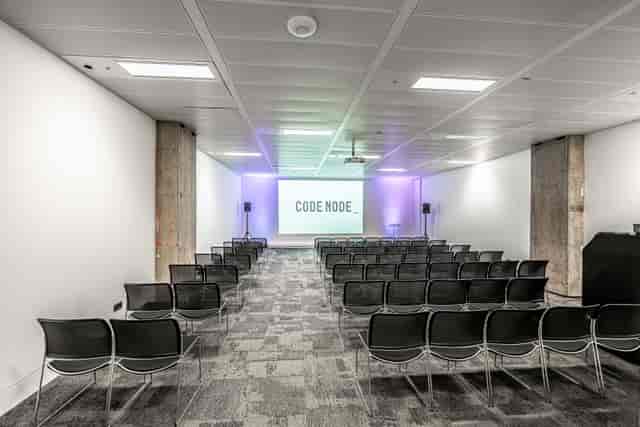 Modern tech event space, projector screen, conference, corporate