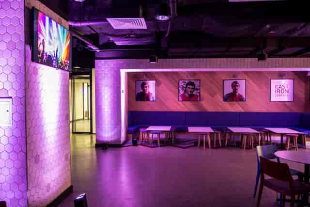 Modern event space at The Boleyn, London Stadium, with vibrant lighting and large screen.