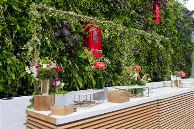 Elegant event space at The Postal Museum with lush green wall, perfect for receptions.