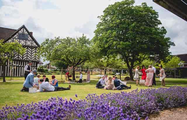 Barn at Blakesley Hall, lush greenery, ideal for weddings and garden parties.