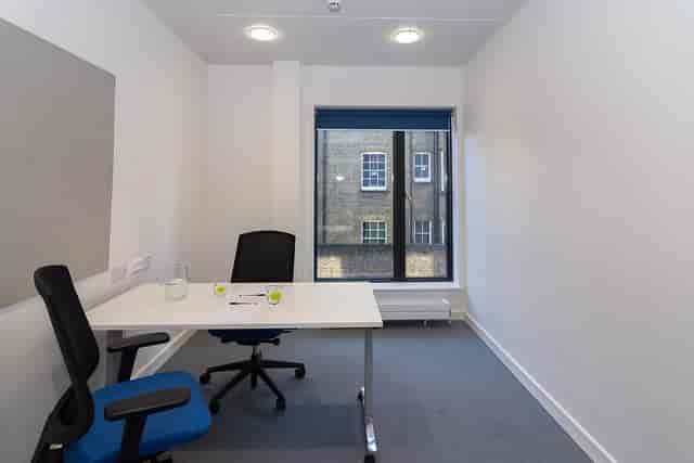 Minimalist meeting room with ergonomic chairs for productive discussions in Camberwell Library.