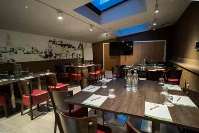 Edinburgh conference room with long table, natural light, ideal for meetings and events.