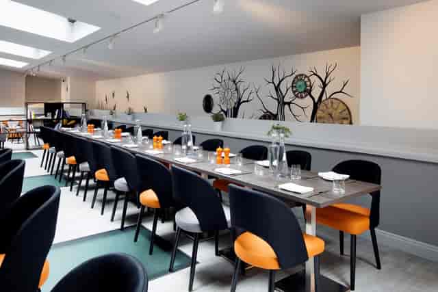 Modern event space in Edinburgh with elegant table and stylish chairs for corporate gatherings.