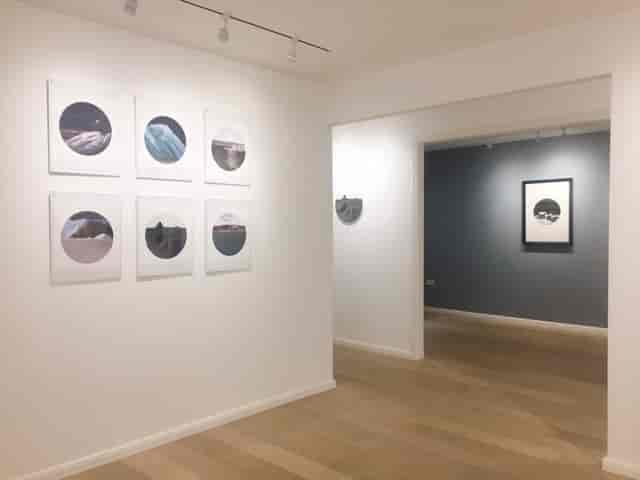 Modern event space in Arthill Gallery with framed artworks, ideal for art exhibitions and receptions.