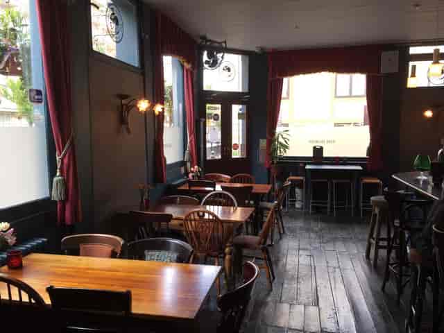 Cozy rustic pub venue with warm lighting for intimate events and gatherings.