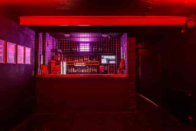 The Cage bar, moody lighting, cocktail party, networking