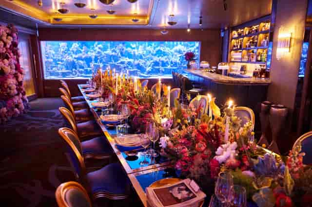 Elegant dining table in Coral Reef Room at Sexy Fish, perfect for upscale events.