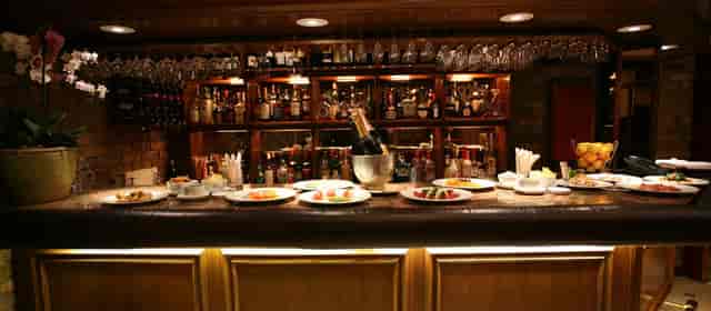 Main Restaurant bar in Bolton's with champagne, ideal for networking events and celebrations.