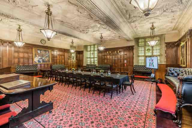 Elegant meeting room with wood paneling, ideal for high-level meetings and events.