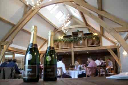 Rustic Oak Barn event space with exposed beams, perfect for gatherings and corporate events.