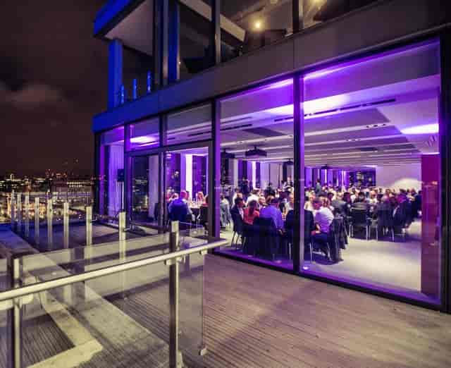 Sophisticated evening event at Sea Containers, featuring elegant purple lighting and city views.