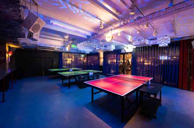 Vibrant event space with ping pong tables for team-building and social gatherings.