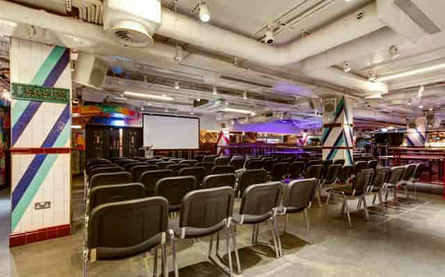 Versatile conference space with black chairs and vibrant decor for presentations in Shoreditch.
