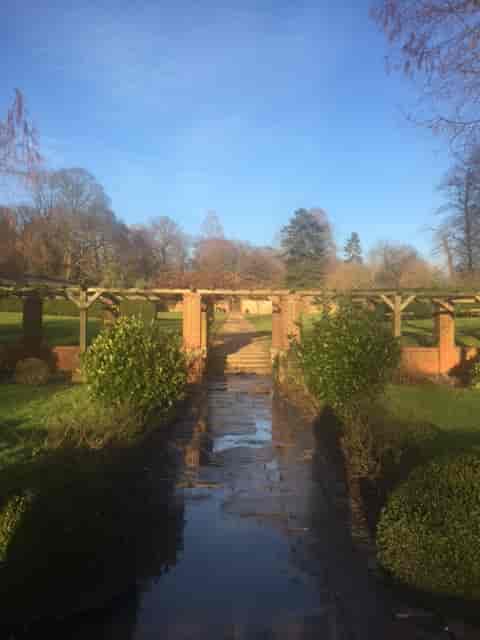 Main Lawn in Cannizaro Park, lush greenery archway, ideal for weddings and corporate events.